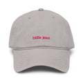 A light gray dad hat baseball cap with 'billie jean' embroidered in pink lowercase letters on the front, shown against a plain white background.