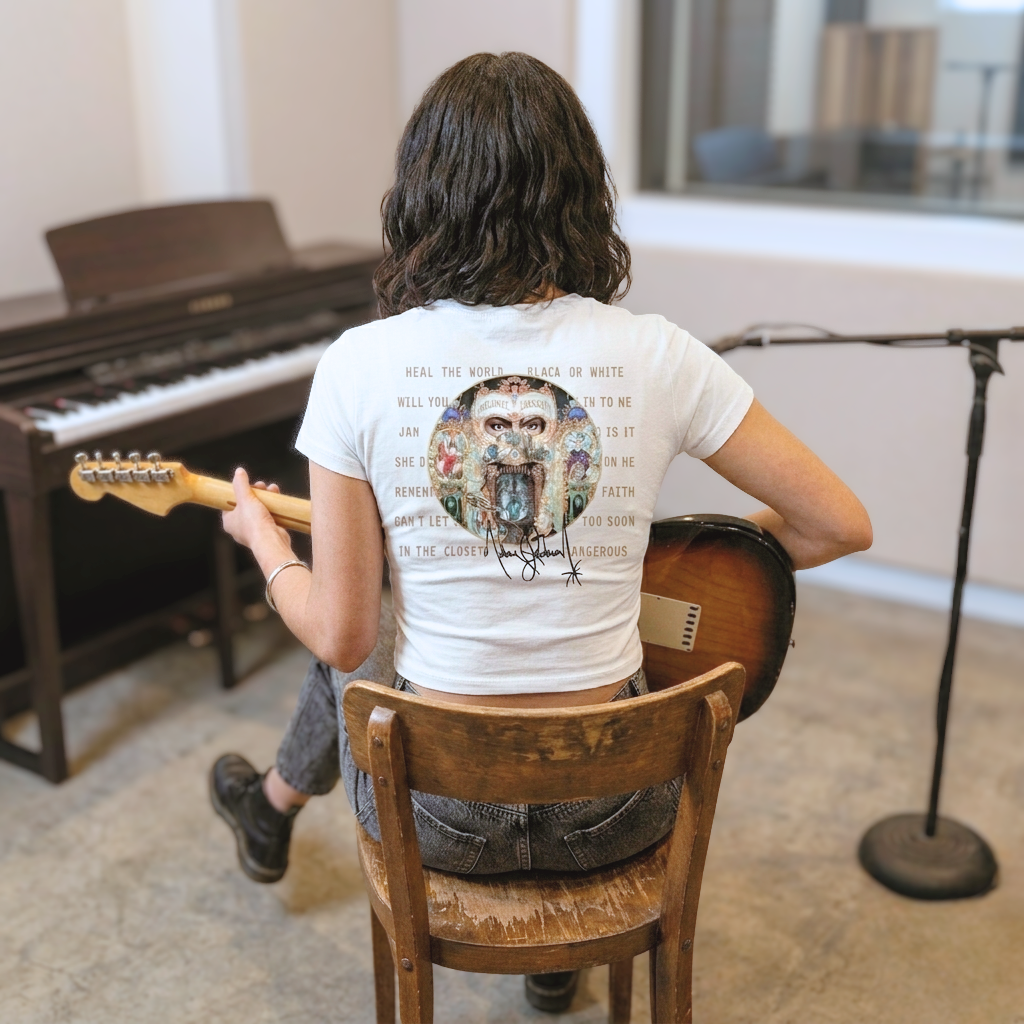 Person playing guitar in a room with musical instruments