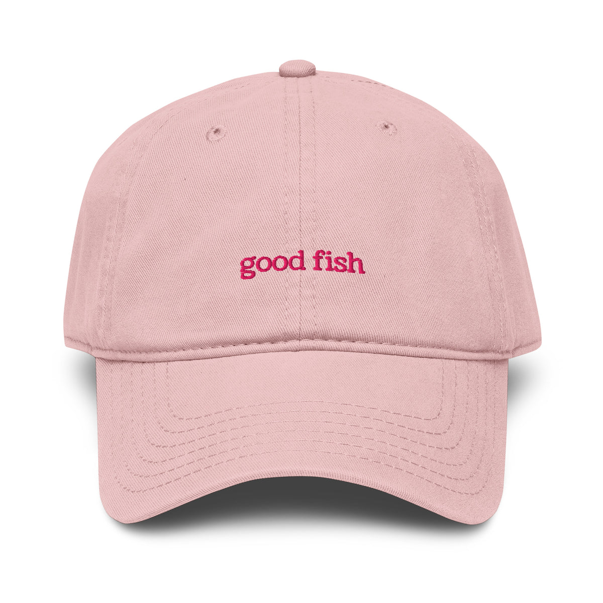 A light pink cotton baseball cap with 'good fish' embroidered in pink on the front, shown against a plain white background.