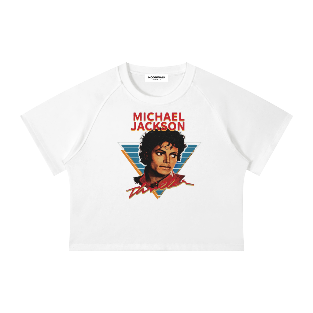 A white raglan crop top t-shirt featuring a graphic print of Michael Jackson with the text 'MICHAEL JACKSON' in red above a stylized portrait.